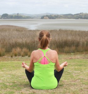 Donna-sitting-yoga-on-the-beach